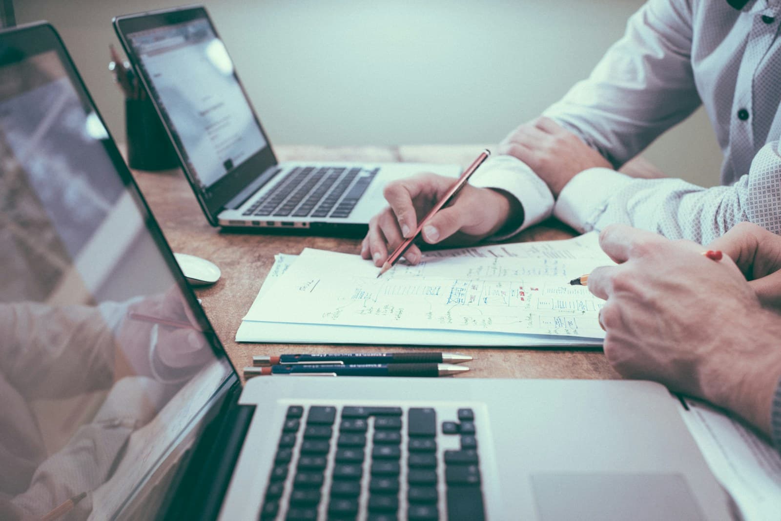 Two people reviewing documents together at a desk